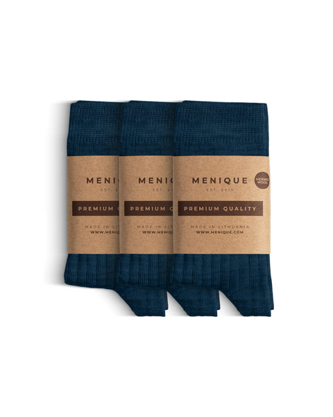 Un paquete de 3 pares de calcetines para niños en azul oscuro, de lana merina acanalada, con etiquetas que dicen "Menique Calidad Premium".