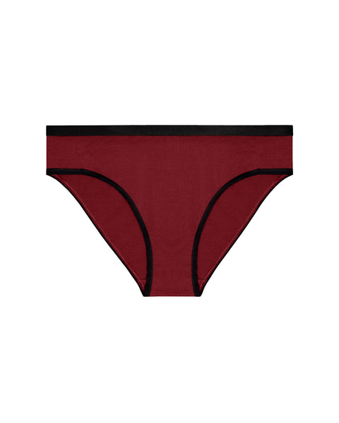A flat-lay product shot of women's bikini-style underwear in a dark, royal cherry red color. It features a contrasting black elastic waistband and black trim around the leg openings. The background is pure white.