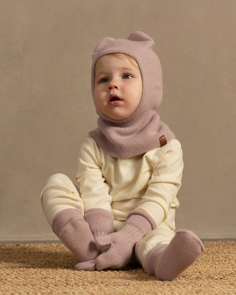 Little girl wearing merino wool long sleeve top and pants with knitter merino wool cashmere balaclava and mittens in pink color