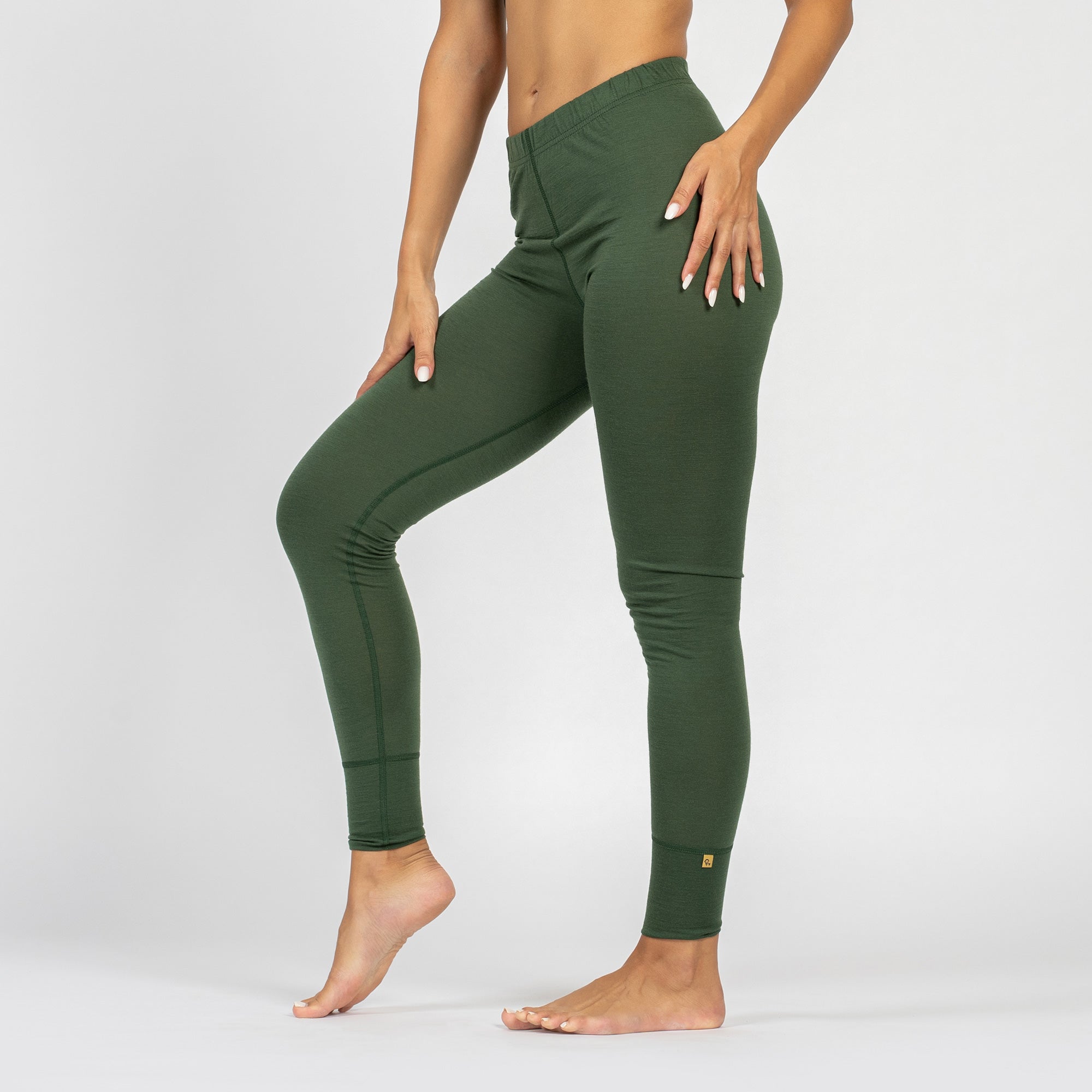 Leggings térmicos de lana merina verde oscuro para mujer, vista lateral.