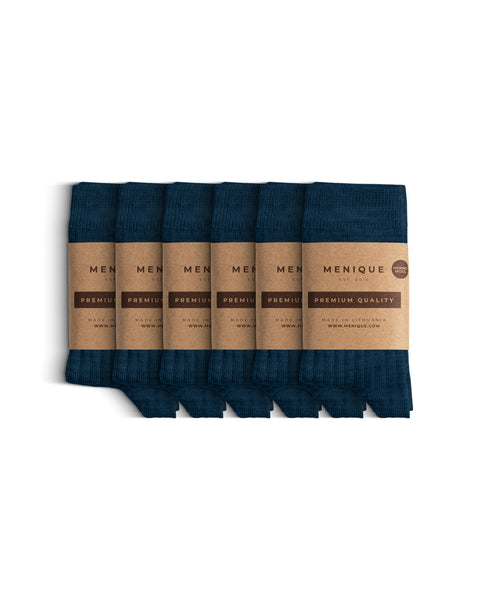Six pairs of blue thin ribbed kids’ socks arranged side by side, each wrapped in Menique brown paper packaging marked ‘Premium Quality.