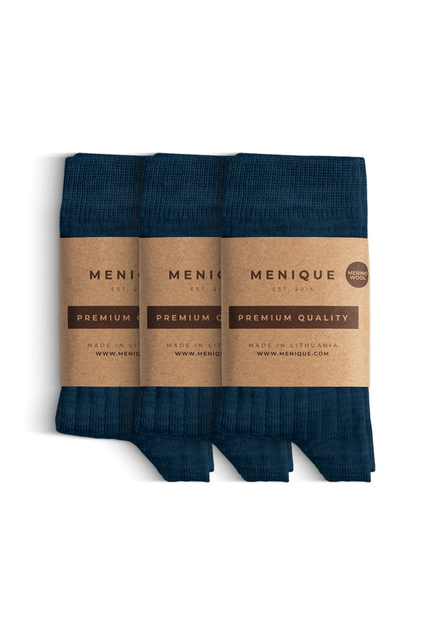 Un paquete de 3 pares de calcetines para niños en azul oscuro, de lana merina acanalada, con etiquetas que dicen "Menique Calidad Premium".