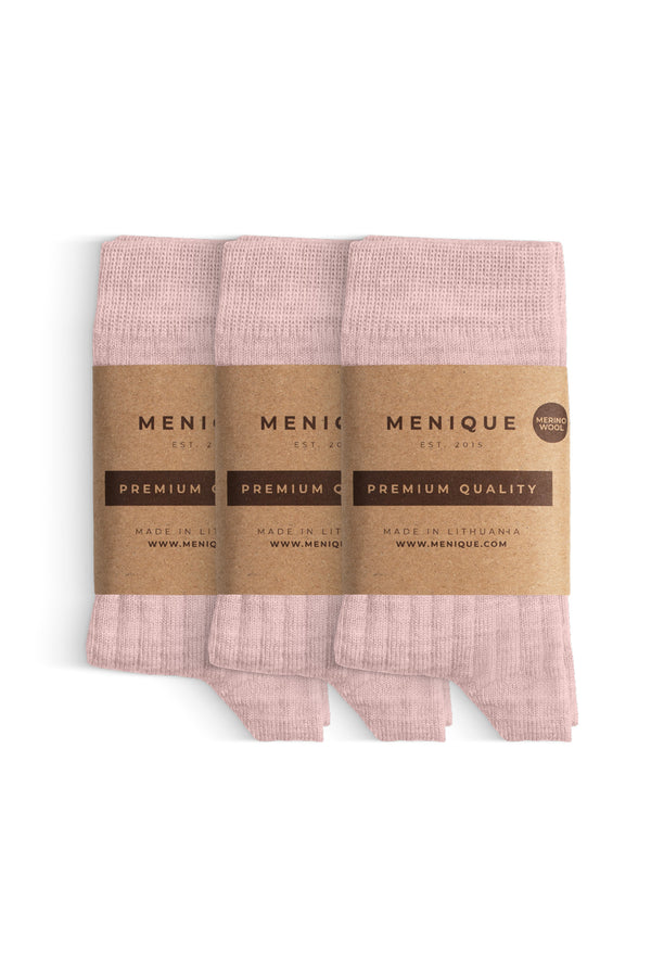 Un paquete de 3 pares de calcetines para niños en color rosa pálido, de lana merina acanalada, etiquetados como "Menique Calidad Premium".
