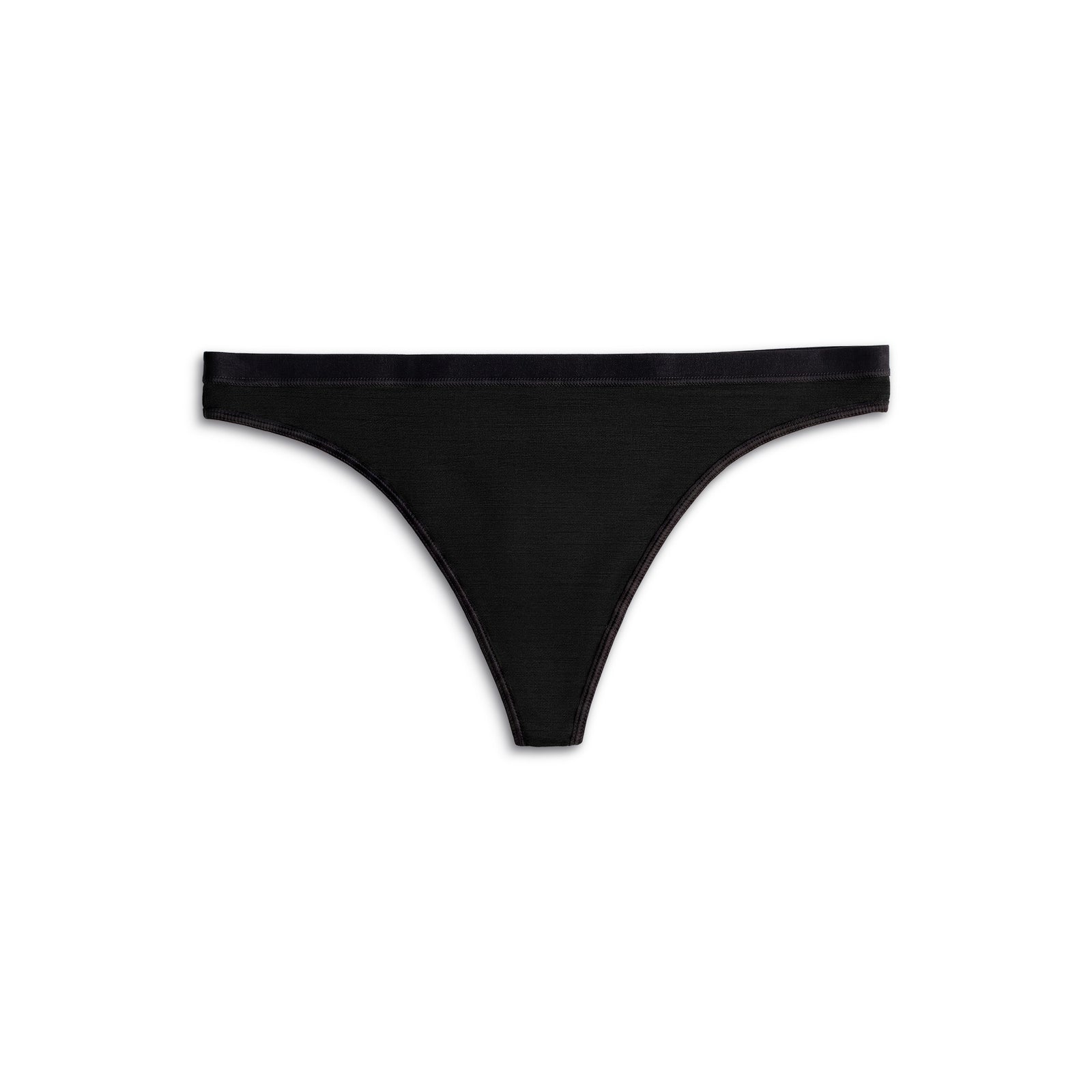 una mujer de rodillas sobre una cama, vistiendo las bragas tanga Merino 160 para mujer de menique en color negro.