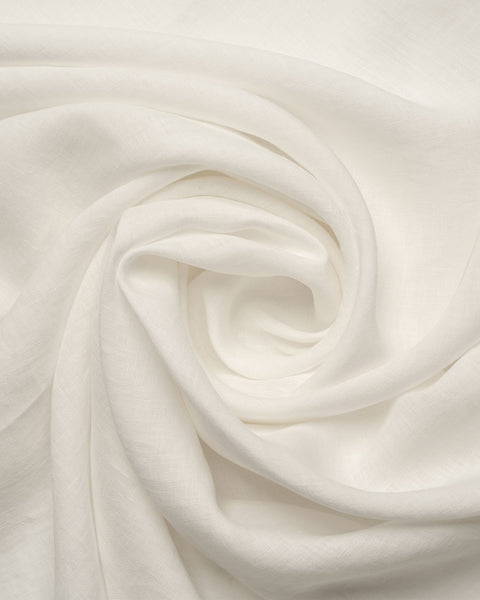 A close-up, overhead view of pure white, textured linen fabric gracefully swirled into a central spiral, resembling a blooming rose. The soft lighting highlights the natural woven texture and the deep, gentle folds of the material.